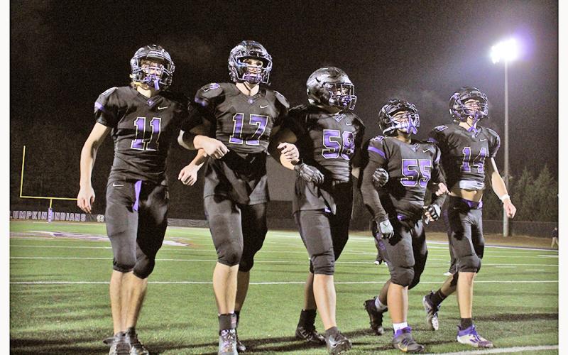 LCHS football seniors (from left) Tanner Kirk, Drew Allison, Joseph Thomas, JoJo Allison and Jared Hoch walk off the field together one final time, following their final game on Friday.