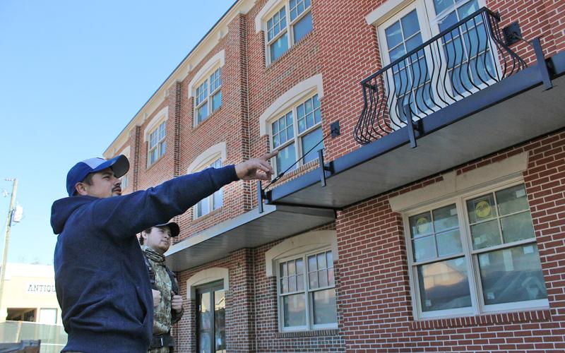 Jose Anaya of Anaya Construction (left) examines details of the new hotel along with Jesus Anaya. Crews are now working on the inside of the building to prepare for the opening planned for December 15.
