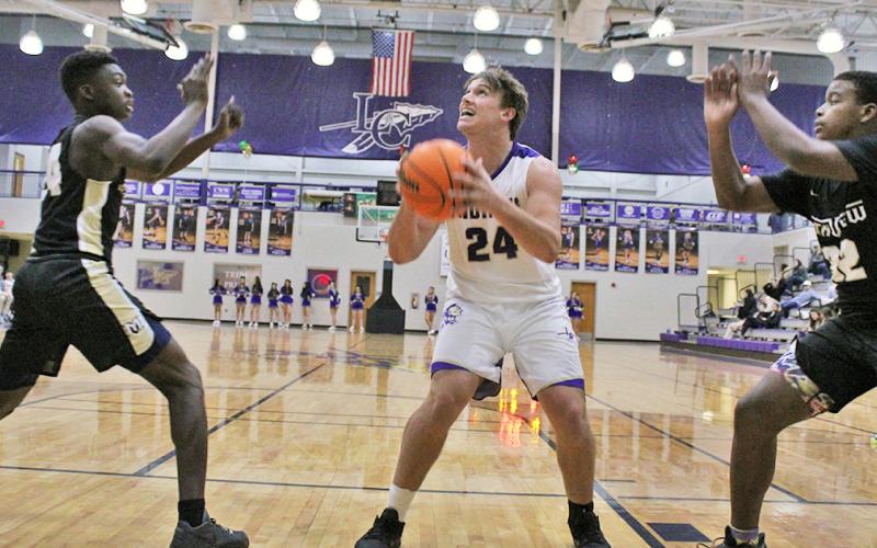 Senior Drew Allison takes a pass down low and looks to put up a shot during the Indians’ first game of the Kelly King Holiday Classic on Monday, December 21 against Mountain View High School. Both teams Lumpkin faced in the tournament challenged them with size and physical presence near the basket, something the Indians haven’t faced very much in the first half of the season.
