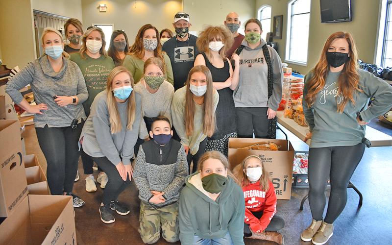 Many volunteers helped distribute Thanksgiving meals to local families in need.