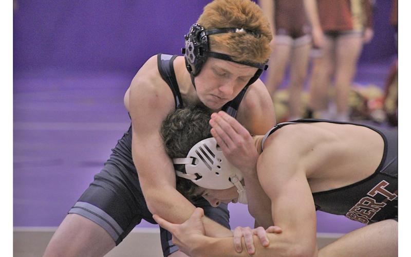 Freshman Austin Marshall tries to control the head of his opponent during his 132 lb matchup against Lambert High School.