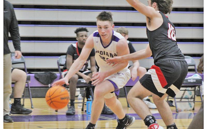 Senior point guard Gus Faulkner drives past a defender during Lumpkin’s game against Flowery Branch on Friday, Jan. 15. Faulkner led the scoring in both games last week, scoring 26 points in Tuesday’s loss to White County followed by a 22-point performance in the team’s win against Flowery Branch.