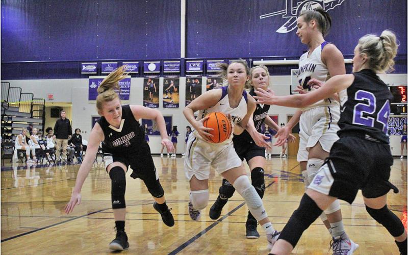 Freshman Averie Jones weaves through a host of defenders toward the hoop for a basket against Gilmer County on Friday. As the team’s leading scorer on the season, Jones adds versatility to an already lethal attack that head coach David Dowse only sees getting better.