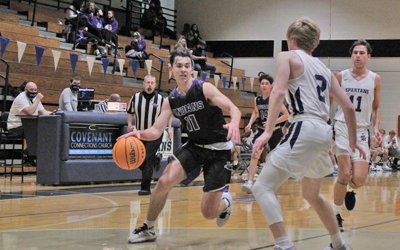 Junior guard Jones Harris drives past a defender toward the basket in the second half of the Indians’ game against West Hall. Harris tied for a game-high 16 points in the crucial region-win.