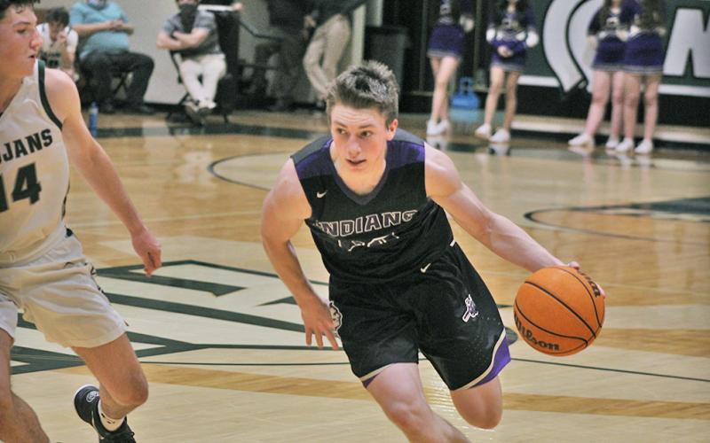 Lumpkin senior captain Gus Faulkner drives to the basket in the Indians’ region tournament game against North Hall.