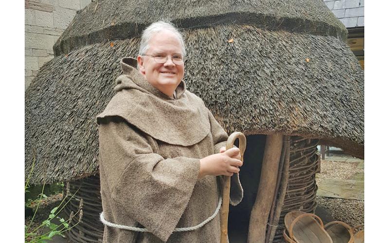Fr. John Hamilton, rector at St. Elizabeth’s Episcopal Church, poses during a 2018 pilgrimage to Northern Ireland at a recreated monastery at North Down Museum.