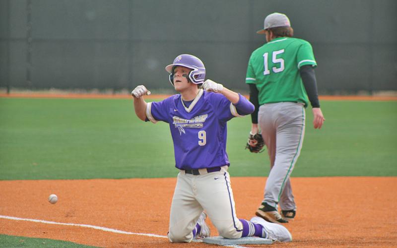 Hayden Cleland flexes for his teammates after sliding in safe for a RBI triple during Lumpkin’s first game of the day against Pickens County. Cleland performed well both on the mound and at the plate.