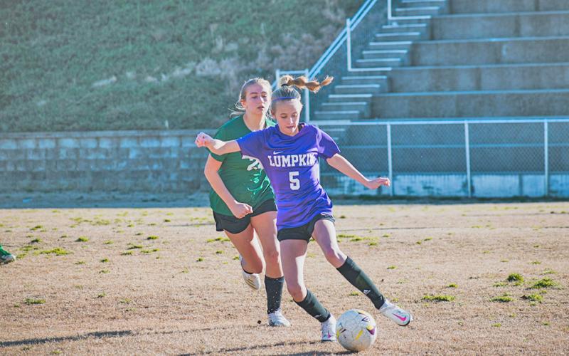 Middle school player Kaitlyn Johnson controls the ball and looks to create a play out wide.