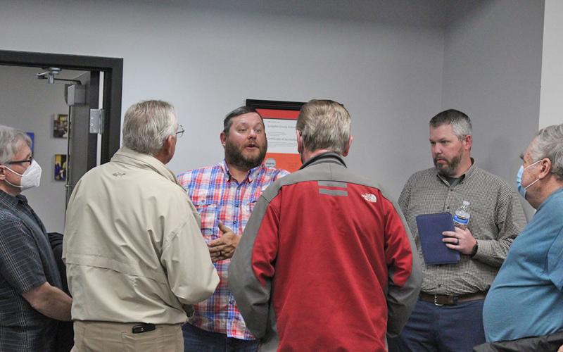 John Dowdy and Adam Scott, far right, talk to other community members about their concerns regarding the alleged controversial lecture given at LCMS in January.