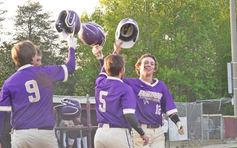 Hunter Cooper (right) celebrates with his teammates after hitting a three-run home run in Lumpkin’s season finale against Dawson County on April 23.
