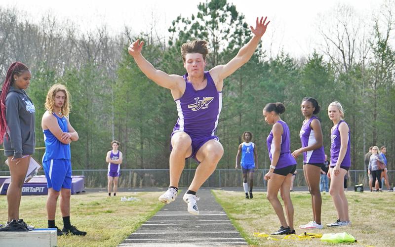 Lumpkin County sophomore Caleb Norrell flies through the air attempting to cover as much distance as possible during the Long Jump event.
