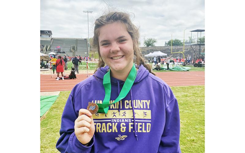 Lumpkin County athlete Grace Jones shows of her medal after placing sixth in the state in Shot Put.