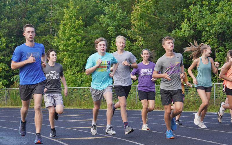 New LCHS Cross Country Head Coach Logan Turner, left, runs alongside his team during a recent summer workout. Turner says he's excited about the new role and the ability to have positive impact on kids' lives.