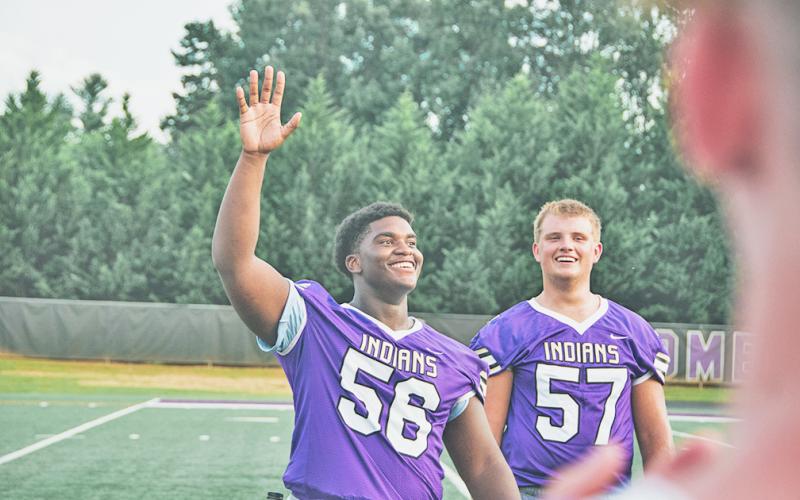 LCHS senior lineman Ricky Hicks waves to the crowd as he’s introduced at Lumpkin County football’s Meet the Indians Night this past Friday. The free event let the entire community come take a first look at the LCHS football team as well as the cheerleaders, band and the other LCHS fall sports teams before the team’s season officially begins next week.