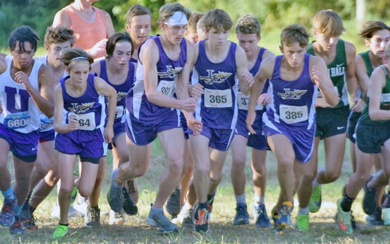 The LCHS Boys Cross Country team makes a dash at the start line during last week’s North Hall Invitational. Behind strong finishes from Ben Sherill and Wyatt Windham leading the way, the boys took first place at the event.