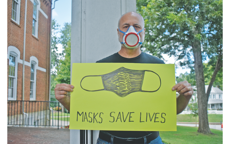 Art professor Jon Mehlferber, is wearing the mask he 3D printed hundreds of last spring.