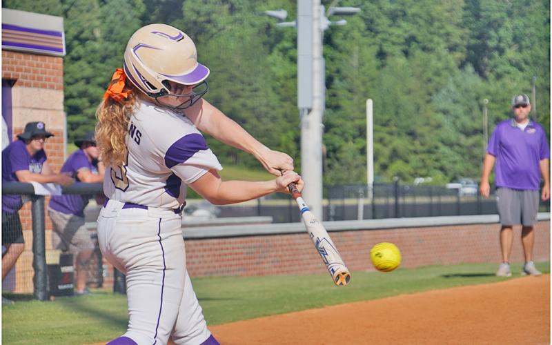 Senior Amma Johnson slams a pitch through the infield for a base hit late in Lumpkin’s 8-2 win over Gilmer County on Friday. With Johnson’s leadoff hit to start the inning, her teammates were able to push her across to start another big inning for the Indians and add some insurance to their lead.