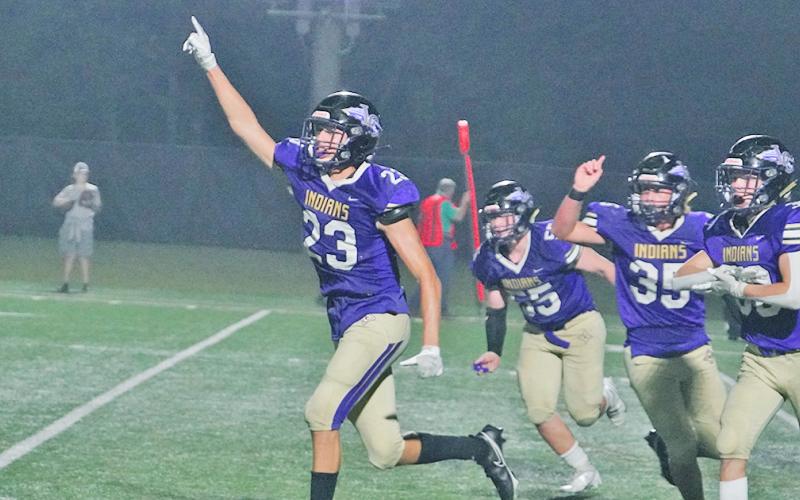 Preston Cox and his defensive teammates run off the field in celebration after Cox made the game-saving tackle on fourth down to give the Indians their second win of the season.