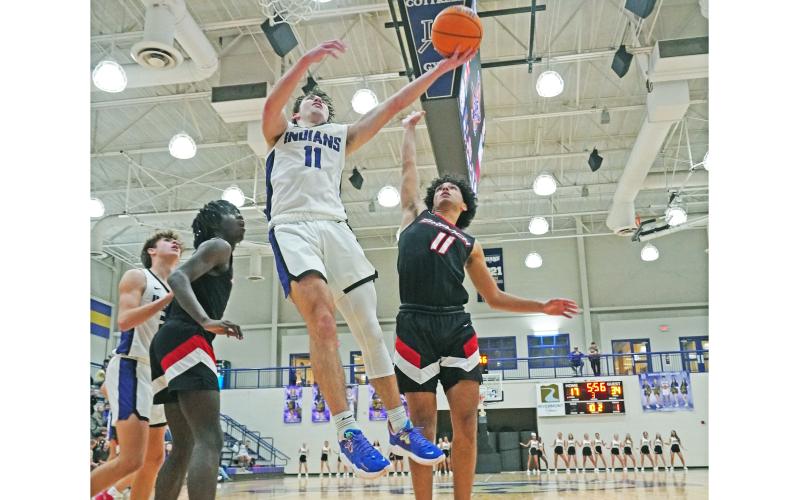 Senior Jones Harris goes up for a layup during a second half in which he scored 17 of his team-leading 20 points as Lumpkin faced off with Flowery Branch in its season opener.