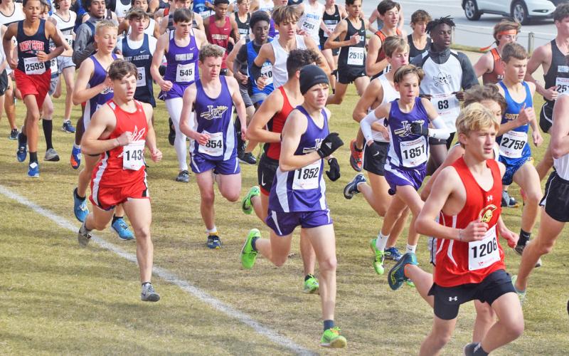 Runners of the Lumpkin County High School Boys Cross Country team try to separate themselves from the pack near the start of the race at the GHSA Cross Country State Championships meet in Carrolton on Friday.