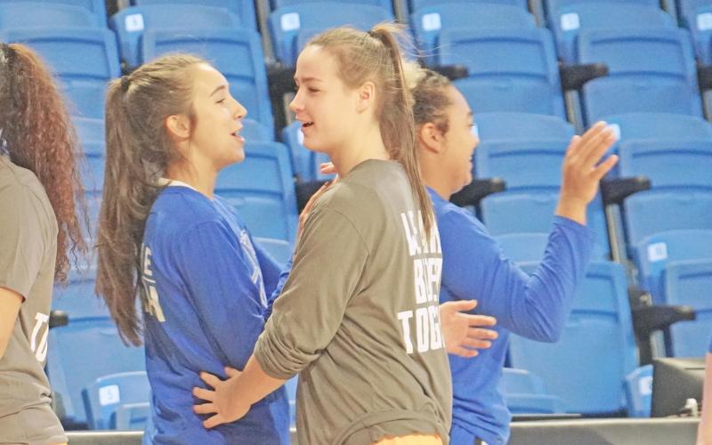Former LCHS teammates Isabel Davenport (left) and Makenzie Caldwell share a brief moment following a face off between their new teams as Davenport’s UNG Nighthawks and Caldwell’s Emmanuel Lions bid each other ‘good game’ following their matchup.