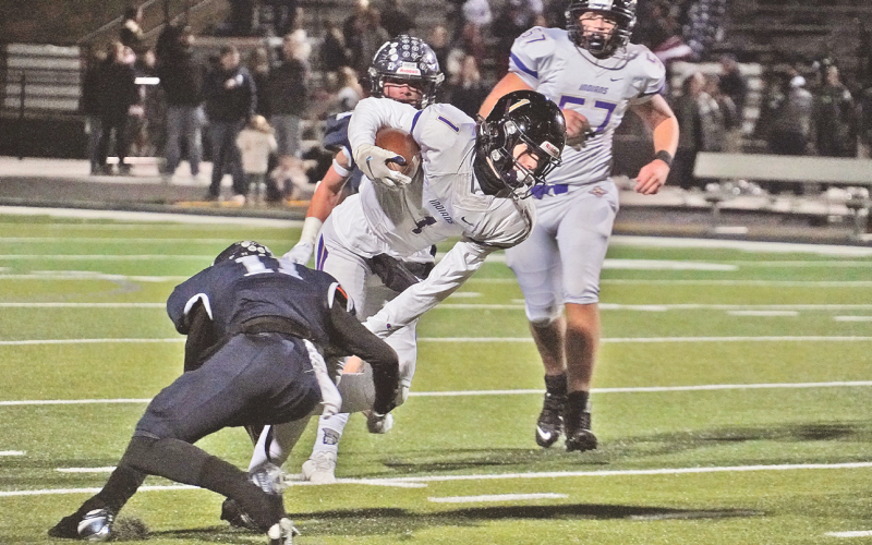 Lumpkin freshman Cal Faulkner lunges forward for extra yards as he’s tackled during the Indians’ final game of the season at West Hall.