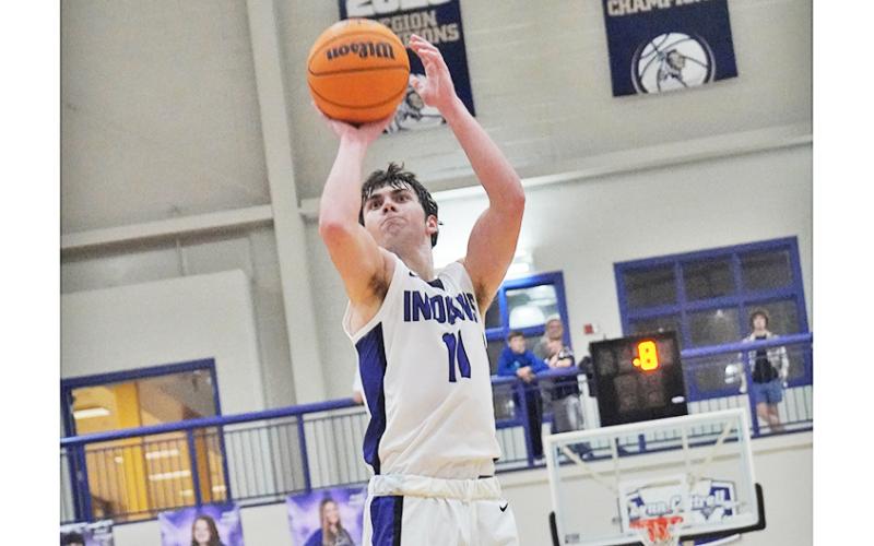 Senior Jones Harris takes aim from three-point range late in Lumpkin’s win against East Forsyth. Harris came in clutch in both of the Indians’ wins on the week.