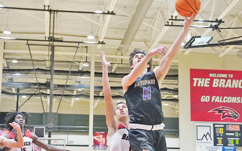 Senior Jones Harris goes up for a layup after successfully driving through the Falcon-filled post. Harris led the Indians with 28 points as the only Indian to score in double digits in the game.