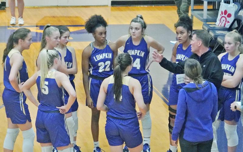 In his first game back since rejoining the team, head coach David Dowse instructs his team with adjustments during a timeout early in Lumpkin’s game against Union County.