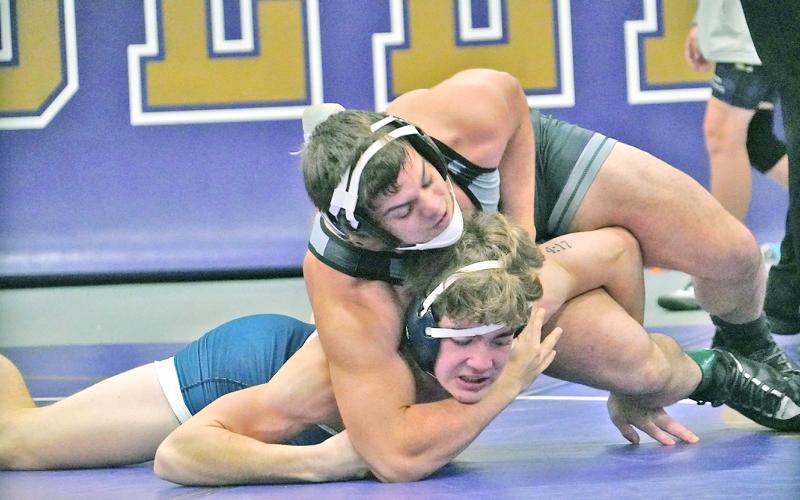 Senior wrestler Austin Evans locks down on his opponent during a match earlier this season. Evans is one of many that head coach Sean Hage is expecting to lead the Indians this season on the mats.