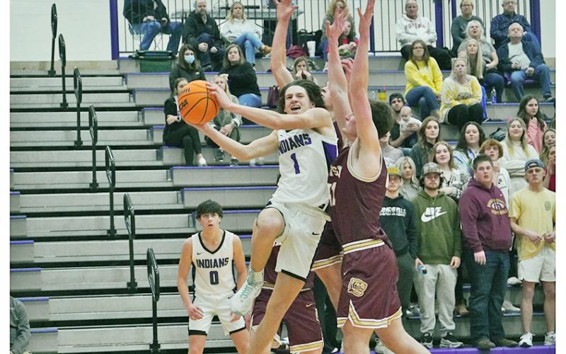 Freshman Cal Faulkner takes on the contact and drives to the basket against two Dawson defenders during Tuesday’s win over the Tigers. Lumpkin notched its first win over their rivals in five years behind a second-half takeover by Faulkner, who scored 15 of his 23 points in the second-half.