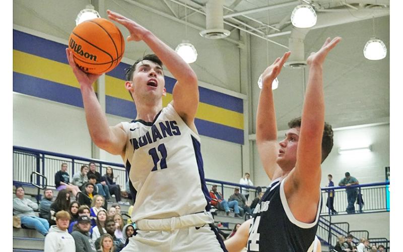 Lumpkin senior Jones Harris puts up a shot with eight seconds left in regulation against West Hall on Friday. Harris was fouled on the play, heading to the line where he converted both free throws to give the Indians a late two-point lead.