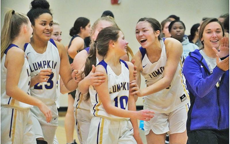 The LCHS Girls Basketball squad celebrates with Breigh Rice (center) following their 72-10 trouncing of West Hall where Rice scored the final points of the game to mark her first career varsity basket.