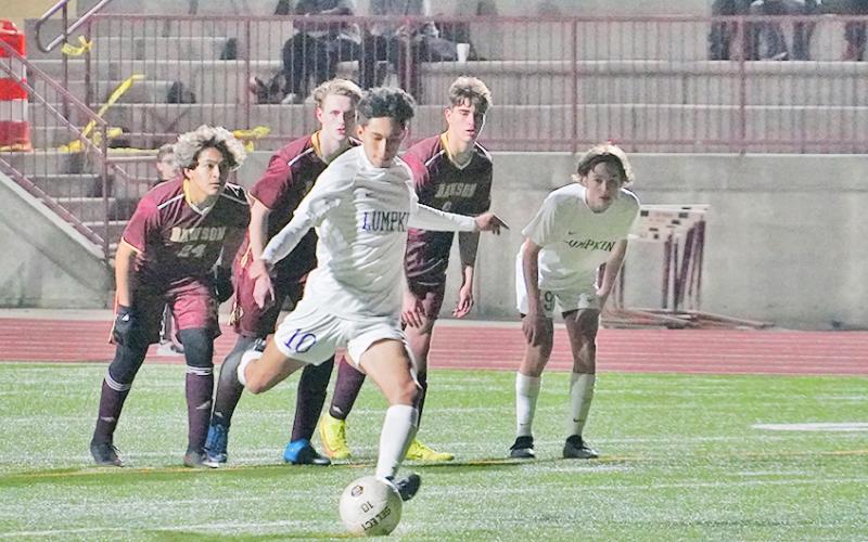 Nicholas Esqueda knocks in the equalizing penalty kick in the second half of Lumpkin’s match against Dawson on Friday night, tying the game at 2-2.