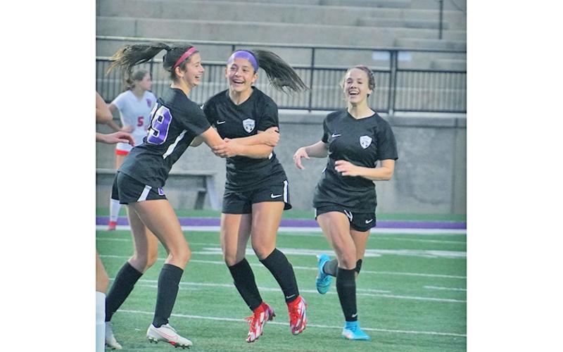 After scoring what turned out to be the game-winning goal in overtime, Andrea Limehouse (left) celebrates with her teammates (from left) Nicole Limehouse and Bri James.