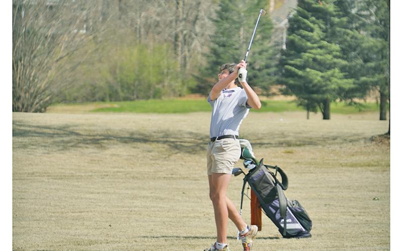 Sophomore Jac Chambers holds his followthrough after chipping his ball onto the green during his round on Tuesday against Fannin County. Chambers led the way for the boys with a score of 46 on the day.