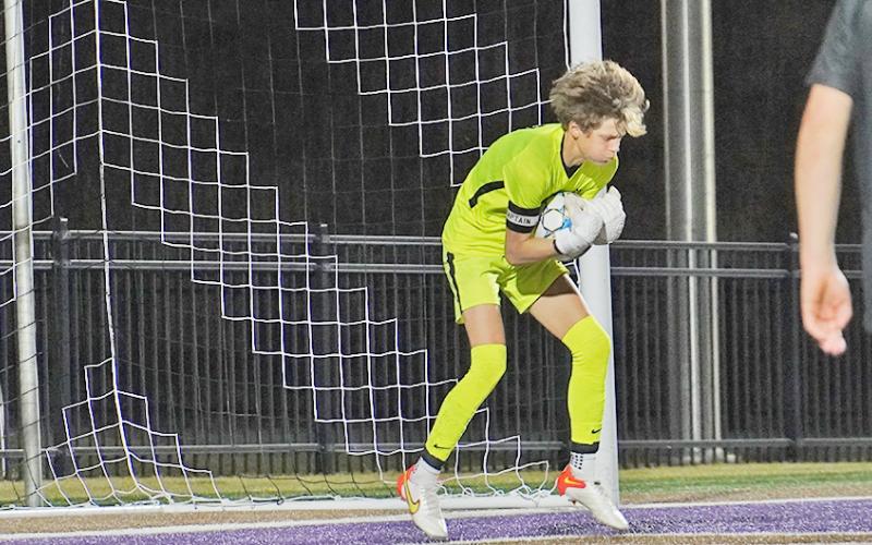LCHS keeper Braunner Boegner makes a save to prevent a goal during the team’s match against East Forsyth on Tuesday. Boegner blocked shot after shot in the match to keep the game going for the Indians.