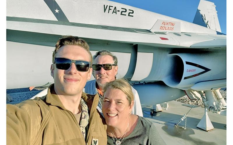 Petty Officer 1st Class Chandler Alexander feels the need, the need to lead in the TOPGUN training program. The Lumpkin County High School alum is pictured alongside his proud parents Steve and Casey Alexander.