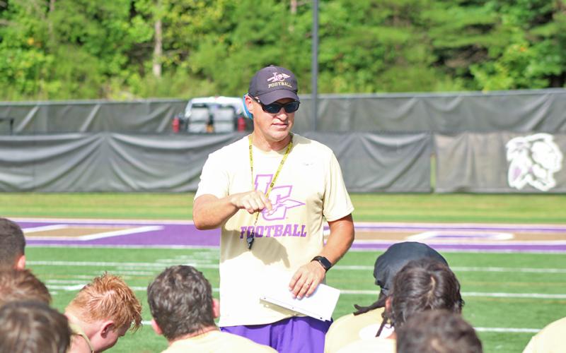 New Lumpkin County High School football head coach Heath Webb speaks to his team after a practice last week.