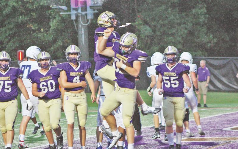 Lumpkin’s Carter Disanto jumps to congratulate Mason Sullens after an Indians’ touchdown.