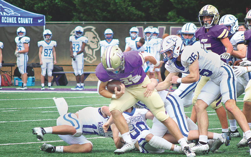 LCHS junior fullback Mason Sullens powers ahead against the Oconee County defense in the Indians Class AAA playoff game on Saturday.