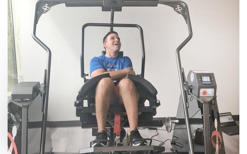 Jon Crais works his core muscles with an AllCore 360 machine. Crais has battled his way back after a traumatic car crash nearly a decade ago.