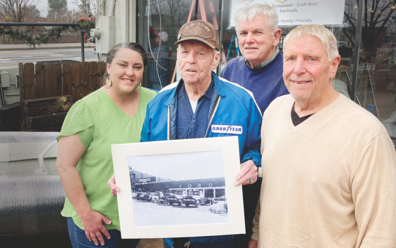 Pictured (from left) operations manager Mea Inglehart, Henry Moore, Jr. (holding a photo of the property from the 1950s), Rick Harris, and owner Art Attaway, took a break during final preparations for the new restaurant last month.