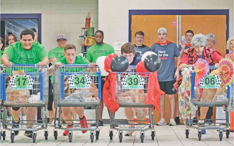 The inaugural Grocery Grand Prix was not only an action-packed event but a profitable fundraiser for the Community Helping Place Food Bank on Saturday. The competition was originally scheduled to take place on the Lumpkin County High School track but moved indoors to the cafeteria due to weather, which made for some tight turns and raucous racing. (photo by Matt Aiken/The Nugget)