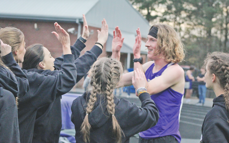 Lumpkin County runner Ben Sherrill celebrates his first pace finish in the 3200-meter event at the Gilmer County meet.