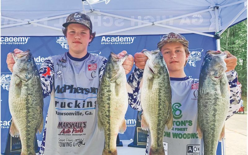 Walker Grizzle and Cooper McDonald show off their catches following a successful tournament on the water.