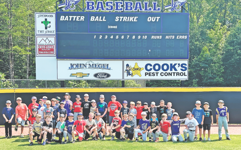 Lumpkin’s young baseball athletes soak up the sun during a group photo following a very successful summer camp.