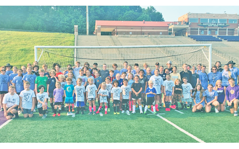 Soccer campers and coaches gather together following all the summer fun.