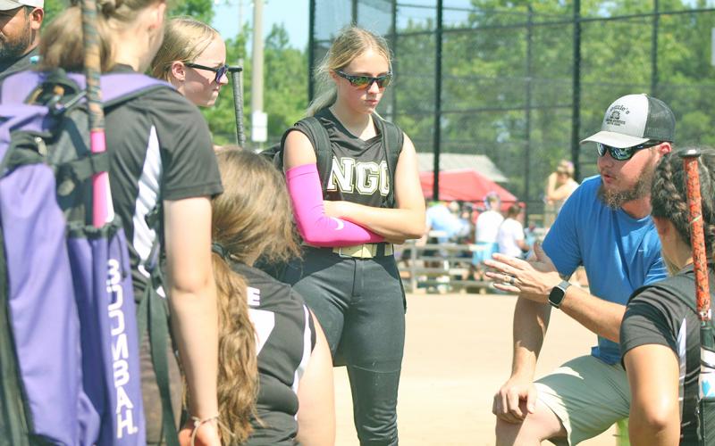 NGG Softball coach Quentin Sears motivates his team following the teams first victory of the tournament, that earned them a second seed standing going into the remainder of games for the event.