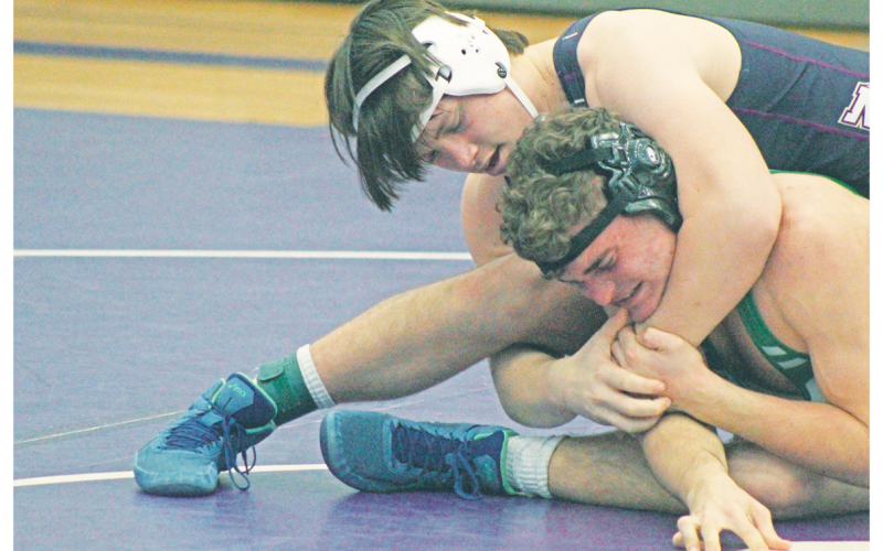 Mike Nichols’ opponent squints in pain as he attempts a cradle.